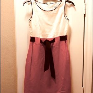 A dress cream, trimmed in brown & bottom is orange